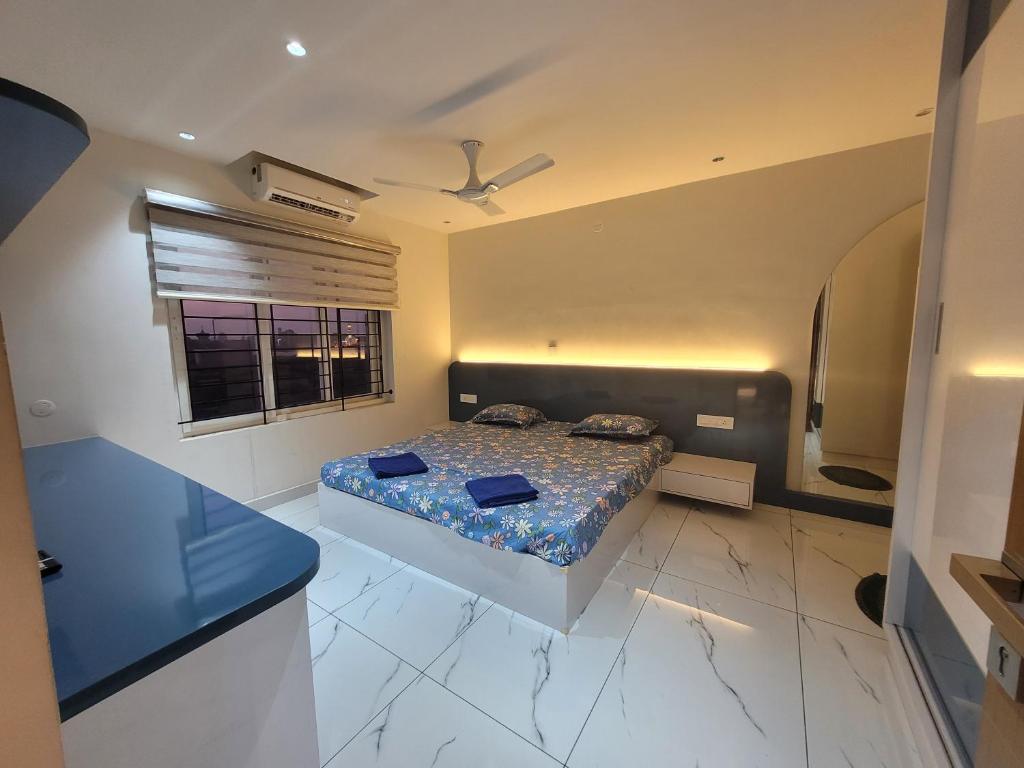 a bedroom with a bed and a window at Gangothrii in Trivandrum