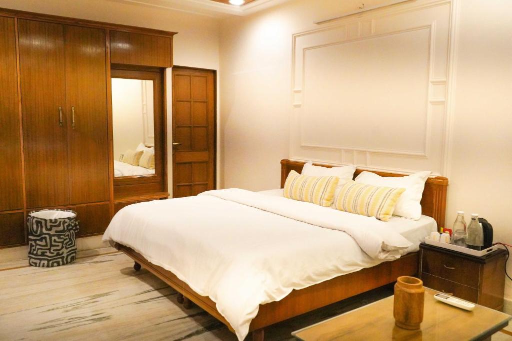 a bedroom with a large bed and a mirror at The Basera in Rishīkesh