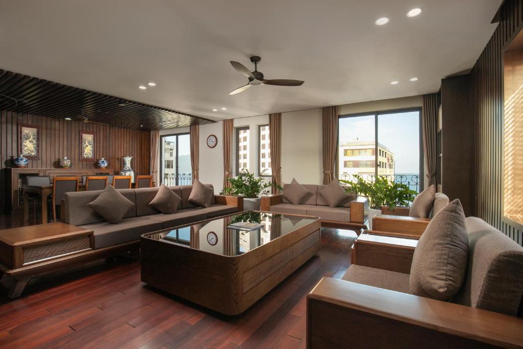 a living room with a couch and a table at Palazzo Boutique Hotel in Danang