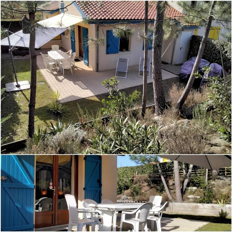 une maison avec des portes bleues, une table et des chaises dans l'établissement Ocelandes, à Saint-Julien-en-Born