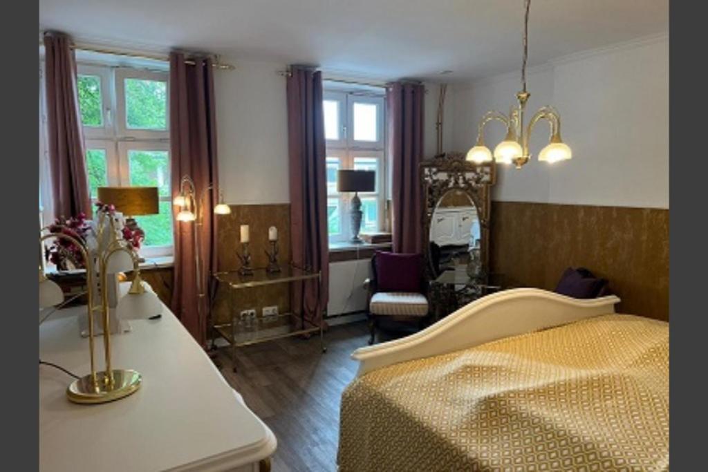 a bedroom with a bed and a table and a chair at Studio-Apartment Rektor Suite 26 am Saseler Markt renoviert in Hamburg