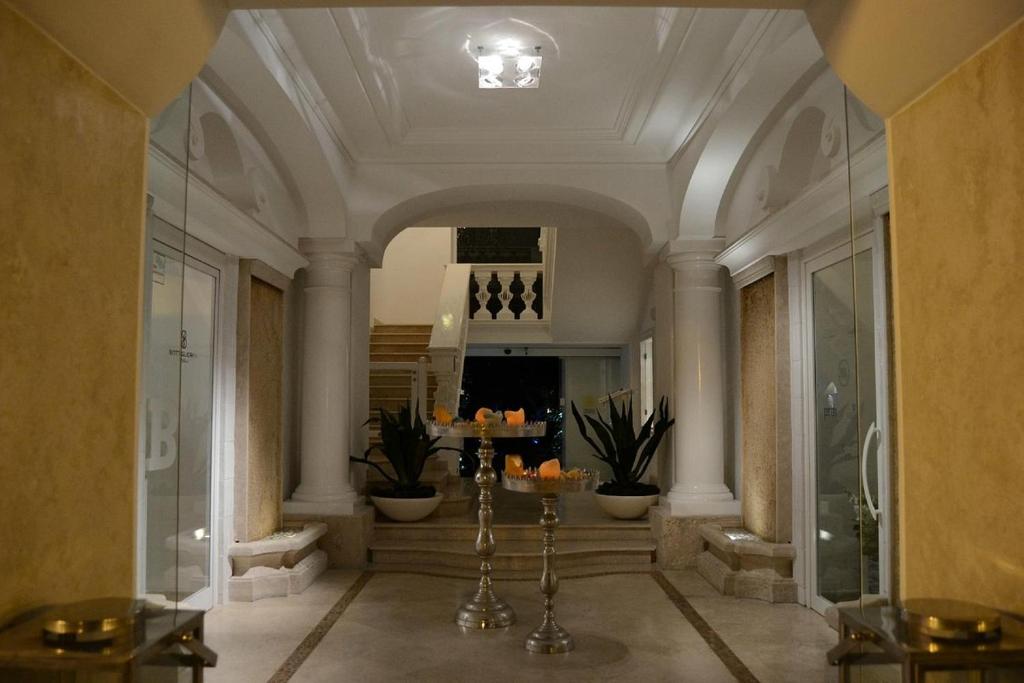 a large hallway with a lobby with a ceiling at Relais Corte Degli Aragonesi in Ischia
