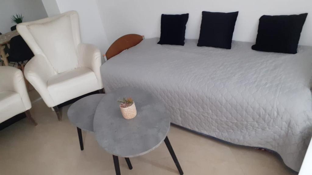 a bedroom with a bed and a table and a chair at בקתת אברהם in Safed