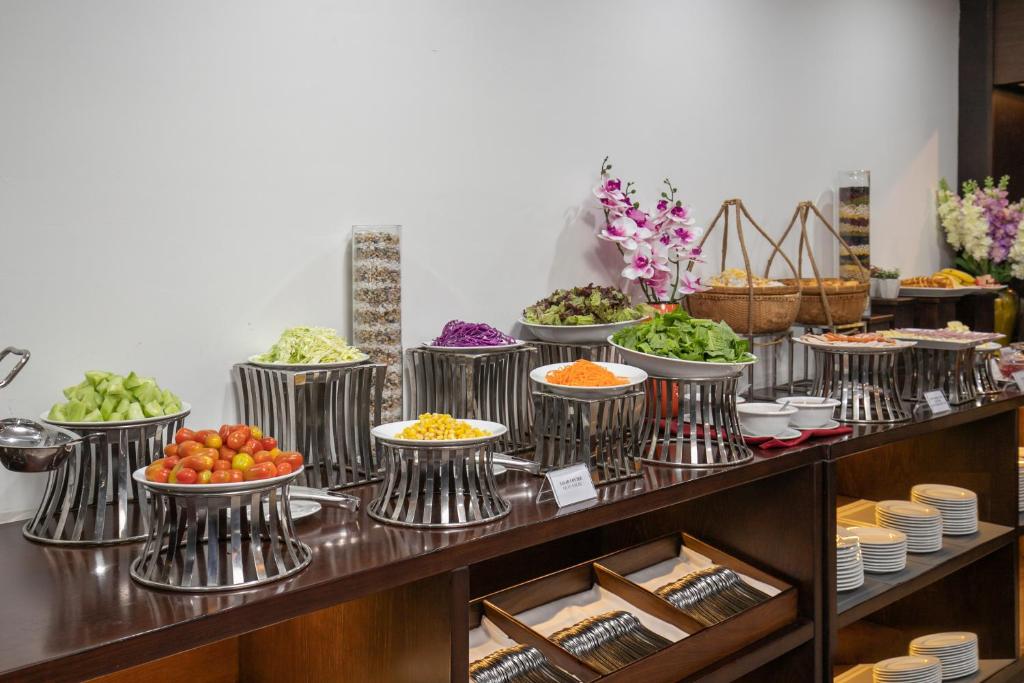 a buffet line with bowls of food on display at Palazzo Boutique Hotel in Danang