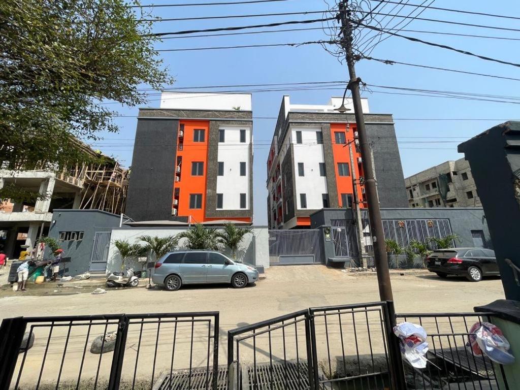 a car parked in a parking lot in front of buildings at SAMBEST Home in Lagos