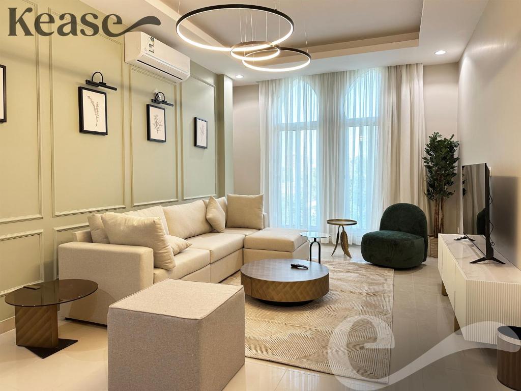 a living room with a couch and a tv at Kease Al-Mutamarat A-14 Timeless History AG50 in Riyadh