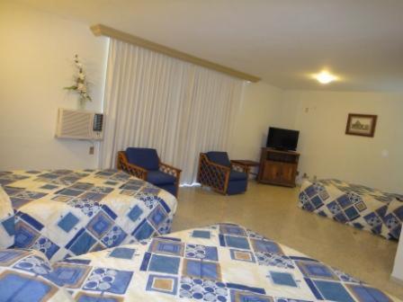 Postel nebo postele na pokoji v ubytování Parque Inn Hotel & Suites