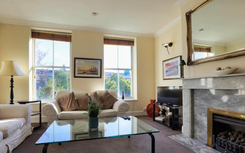a living room with a couch and a fireplace at Walking distance to Grafton St in Dublin