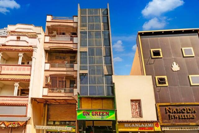 a tall building with windows next to other buildings at ON GREEN RESIDENCY in Secunderabad