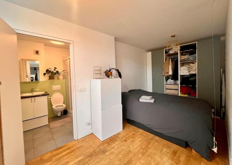 a small bedroom with a bed and a bathroom at 5P Chic Apt, Rooftop, Paris in Paris