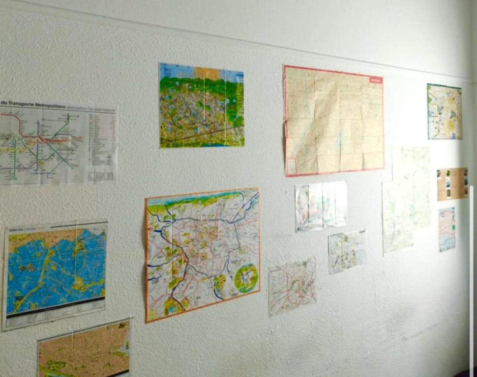 a wall with maps and drawings on it at Casa da Vila Hostel Guest House in Sao Paulo