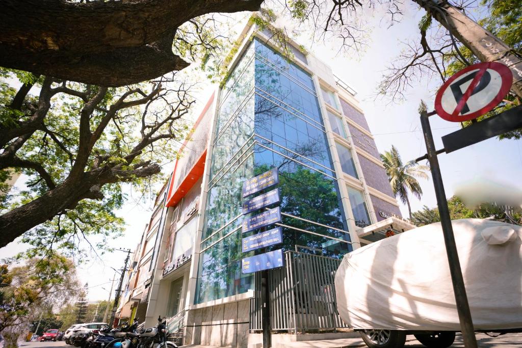 a tall building with a sign in front of it at THE EKAH COMFORTS in Bangalore