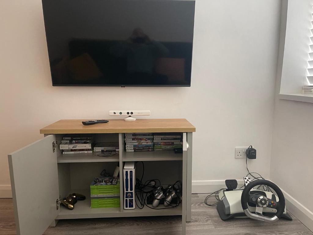 a table with a tv on top of a wall at Minster Leas in Sheerness