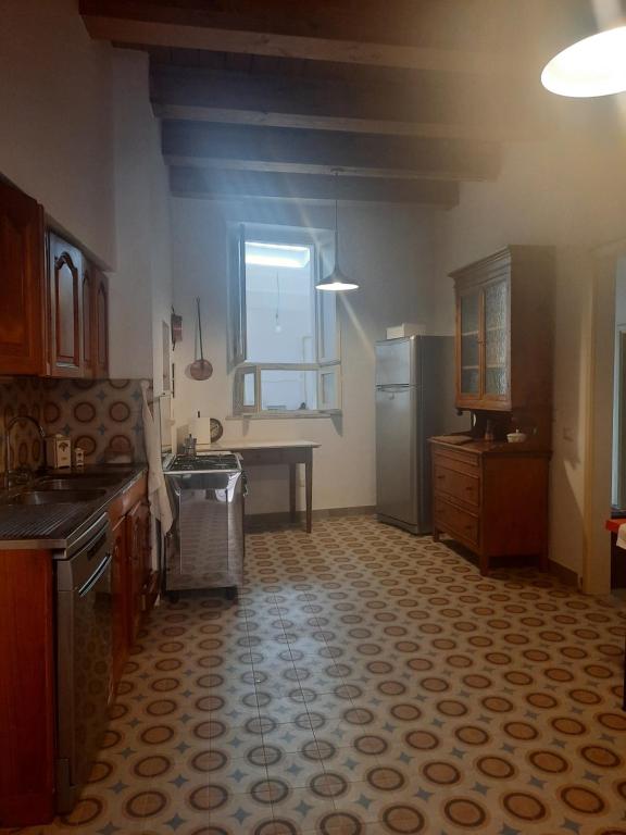 una cucina con lavandino e frigorifero di Casa D'Angelo a Cossignano