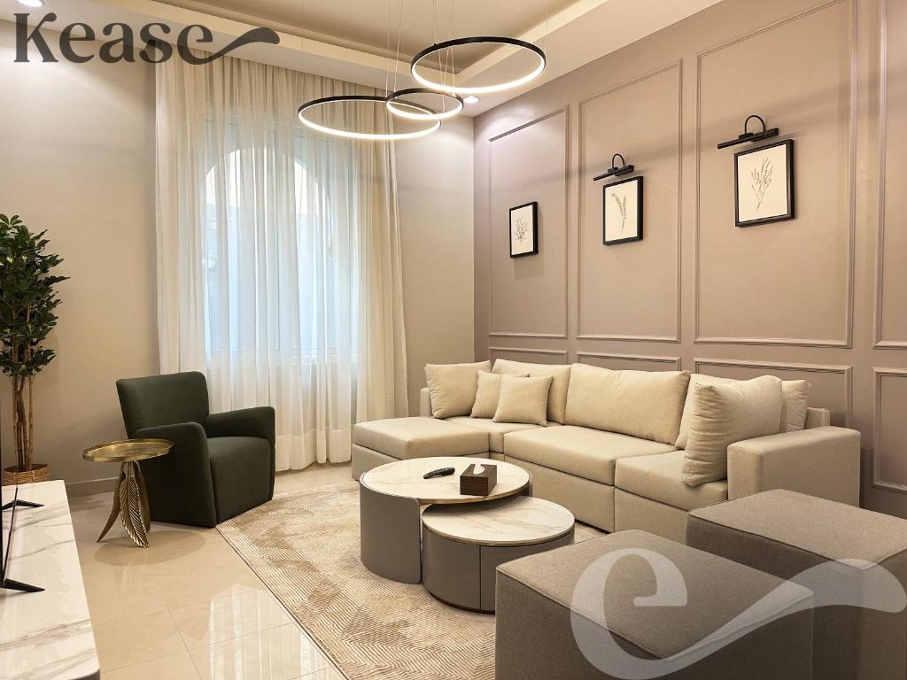 a living room with a couch and a table and chairs at Kease Al-Mutamarat A-5 Timeless History AG76 in Riyadh