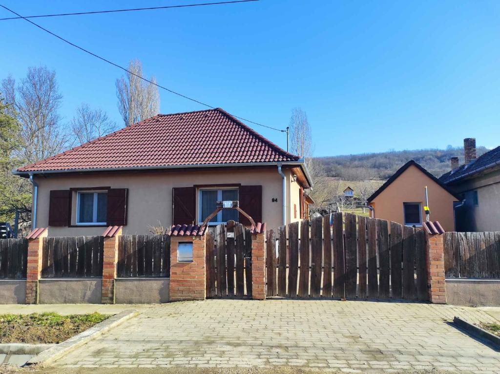 a house with a wooden gate and a fence at Holiday home in Kereki - Balaton 48110 in Kereki