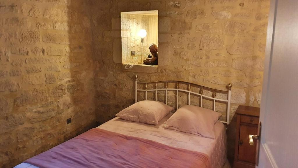 a bedroom with a bed and a mirror in it at Maison Domme Dordogne in Domme