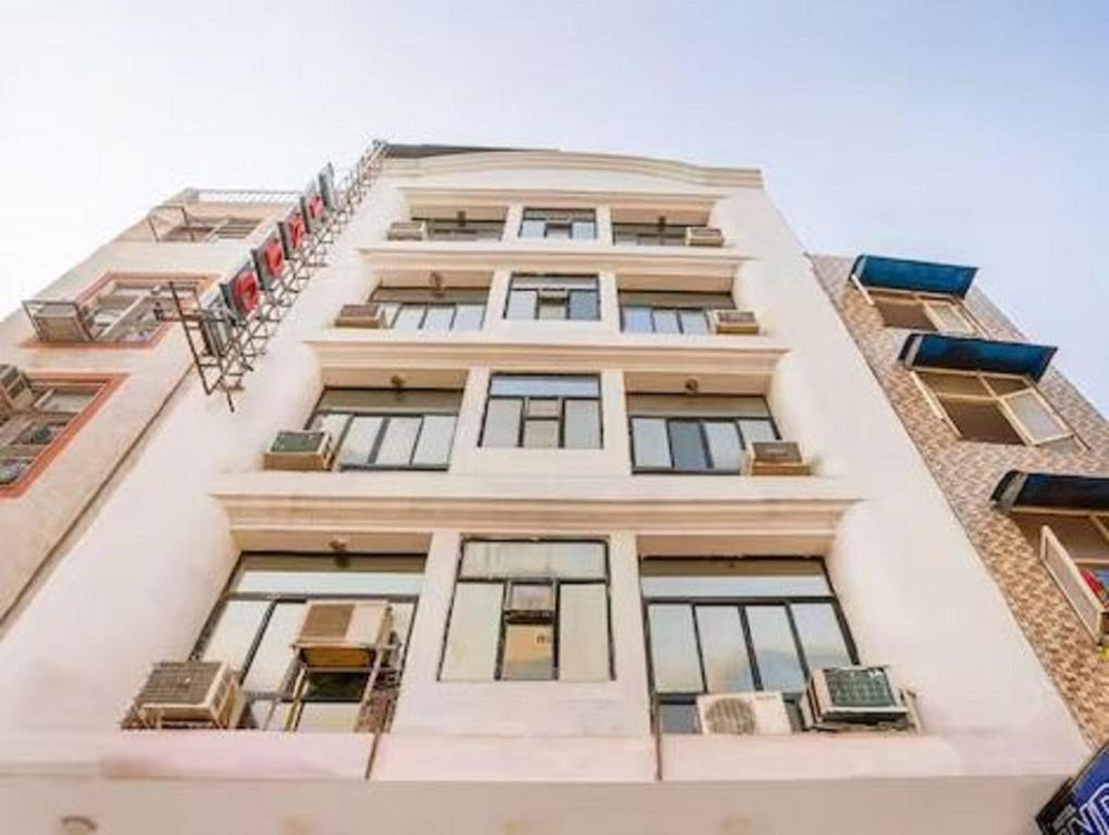 a tall white building with many windows at Hotel Indo Continental in New Delhi