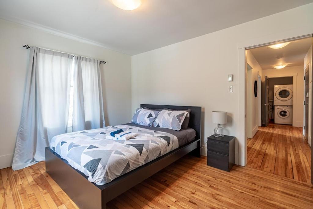 a bedroom with a large bed and a mirror at Beautiful & Spacious Apt #101 in Halifax