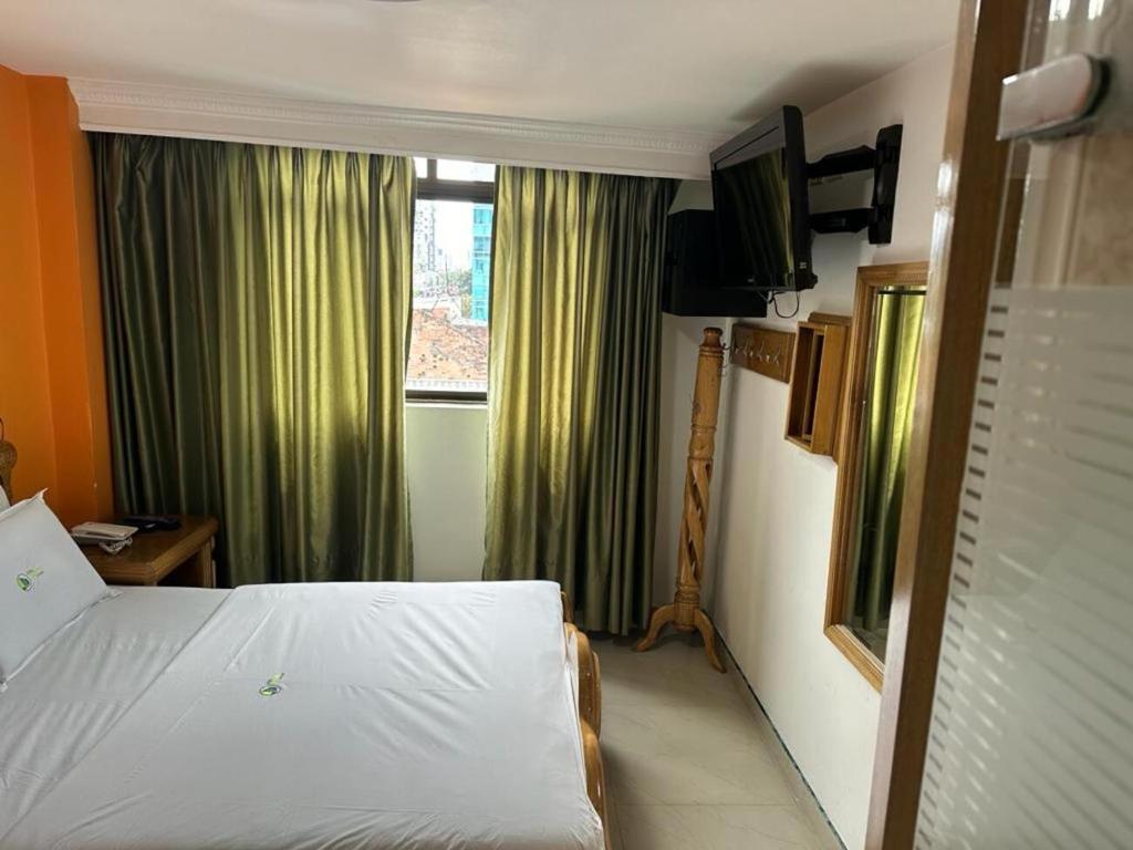 Postel nebo postele na pokoji v ubytování Hotel Bosque Chapinero