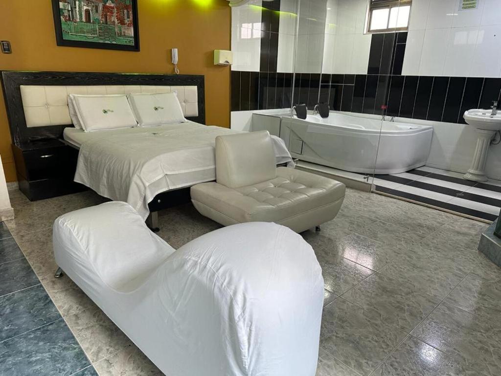 Postel nebo postele na pokoji v ubytování Hotel Bosque Chapinero