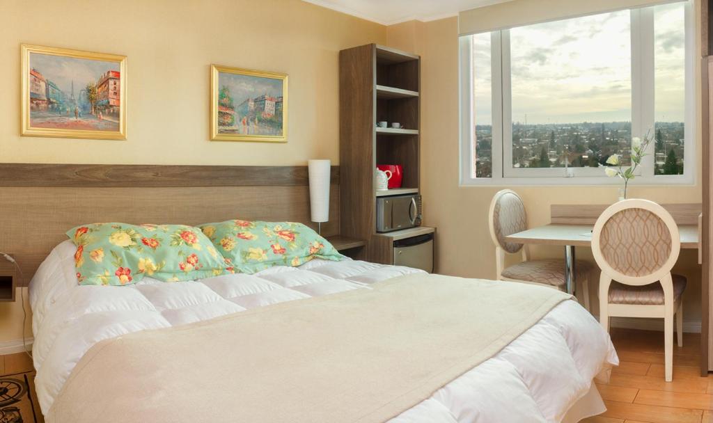 Tempat tidur dalam kamar di Hotel Aranjuez