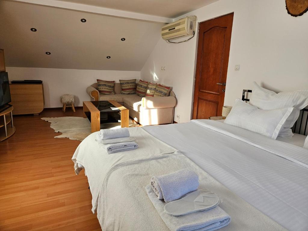 a bedroom with a large bed with towels on it at Casa Ana in Crasna