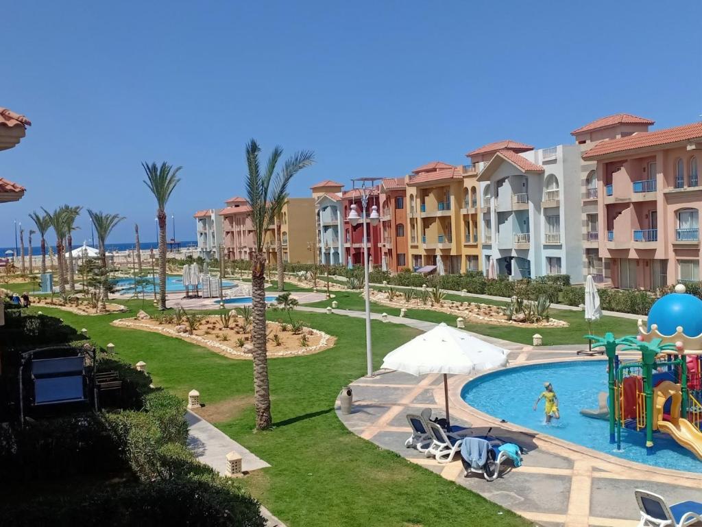 a resort with a pool and a playground at Porto Matroh ViP Spechial in Marsa Matruh