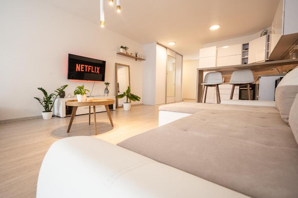 a living room with a couch and a table at Apartmán Belveder s terasou in Banská Bystrica