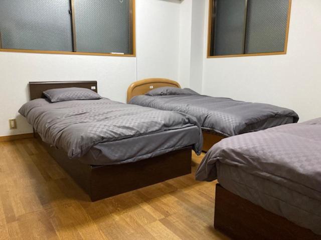 Postel nebo postele na pokoji v ubytování Sky Tree INN Ⅱ（晴樹宿Ⅱ）