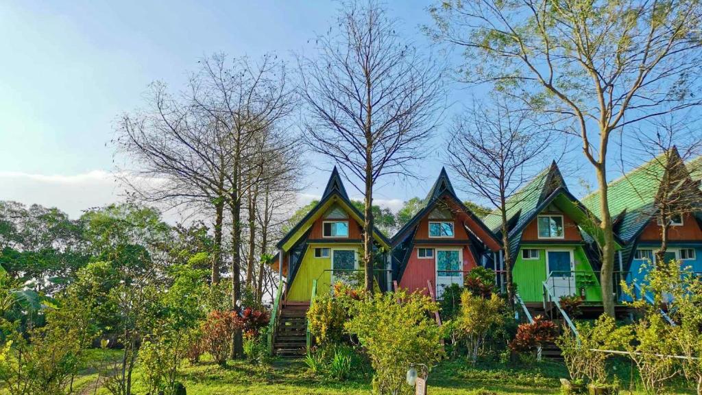 une rangée de maisons colorées avec des arbres en arrière-plan dans l'établissement Kitefarm, à Dongshan