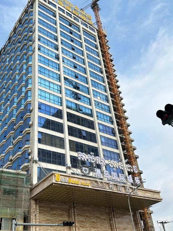 a tall building under construction with a crane at XI AN JIU DIAN Hotel in Sihanoukville