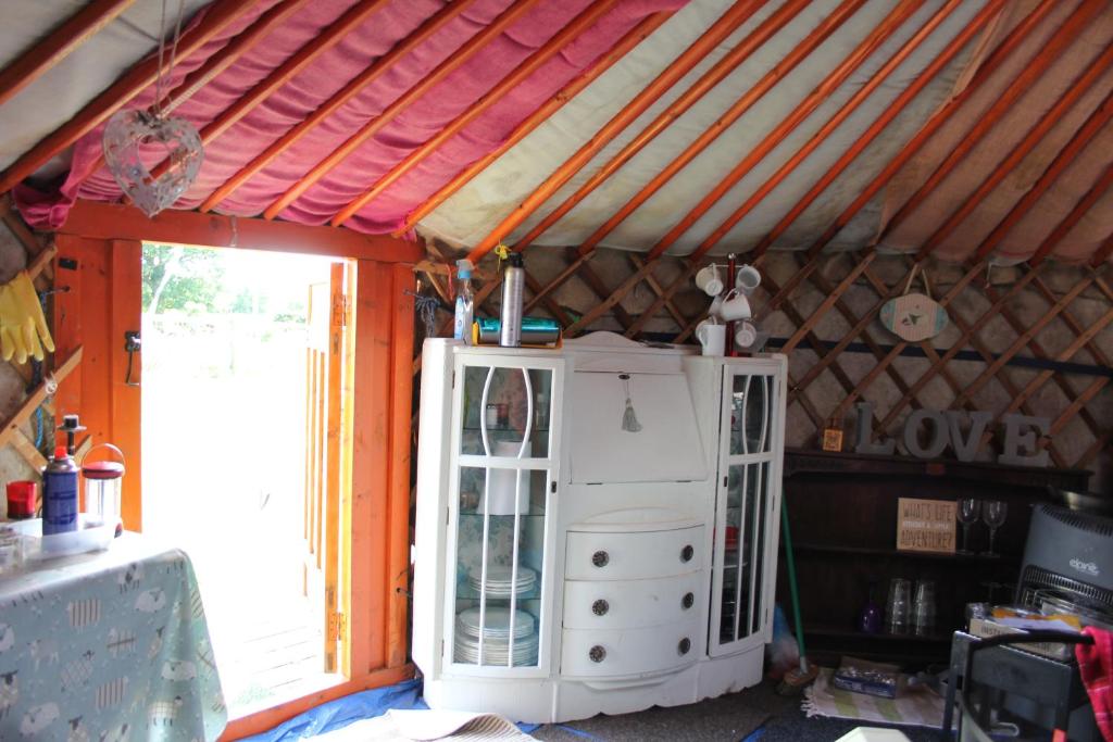 a room with a large window and a white cabinet at Glamping West Midlands in Enville