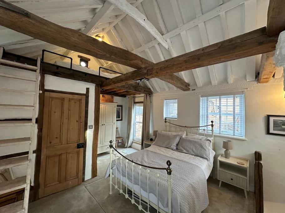 a bedroom with a bed and a wooden ceiling at The Nook Lincoln in Lincolnshire