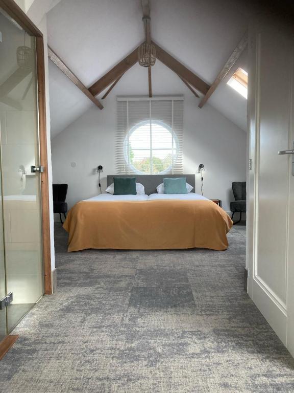 a bedroom with a large bed with a window at Duinstrand Burgh-Haamstede in Burgh Haamstede