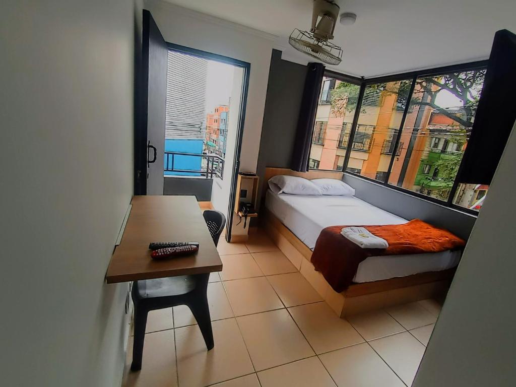 Postel nebo postele na pokoji v ubytování Hotel Ruiseñor Itagui
