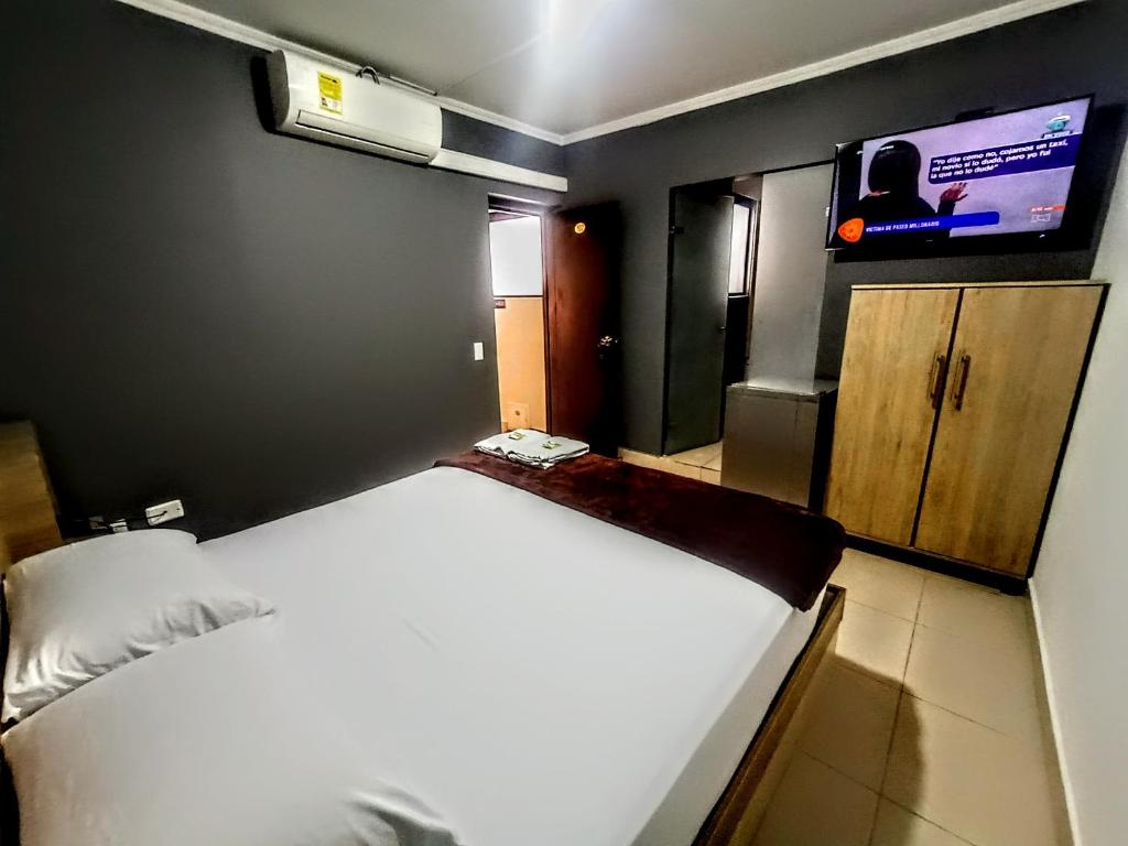 Postel nebo postele na pokoji v ubytování Hotel Ruiseñor Itagui