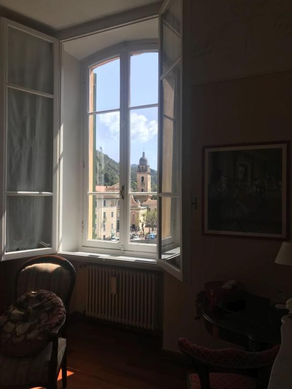 a window in a room with a view of a building at B&B Agapantus in una Villa dell'800 in Dolceacqua