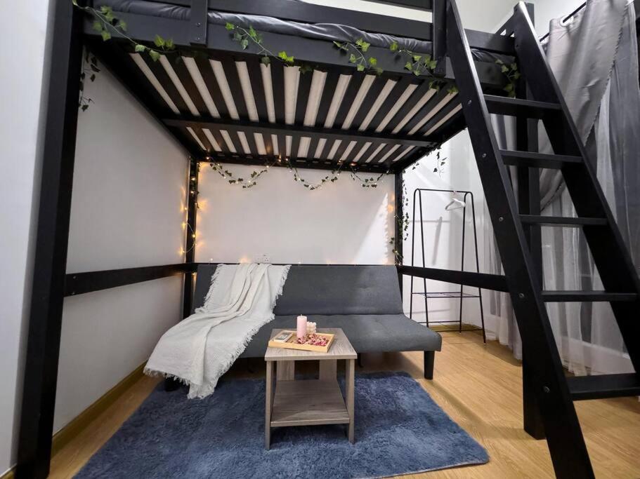 a loft bed with a couch and a table at Wind Serenity & FOC Netflix Access Country Garden Danga Bay 3BR # 6-11 pax by Minshuku in Johor Bahru