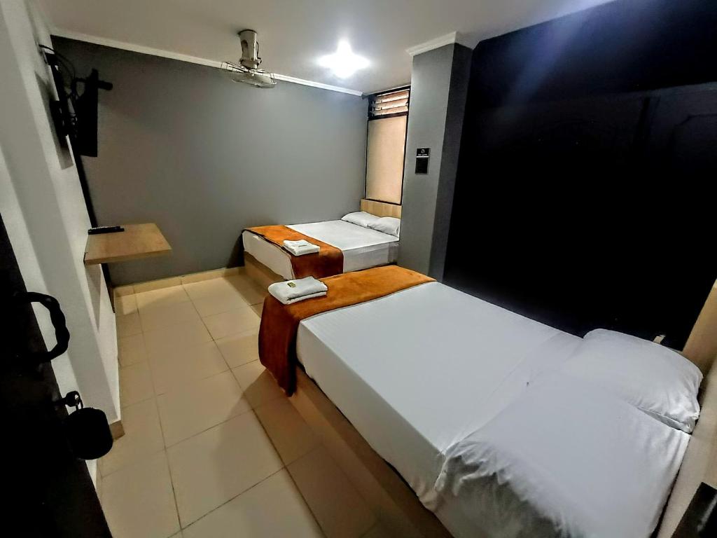 Postel nebo postele na pokoji v ubytování Hotel Ruiseñor Itagui