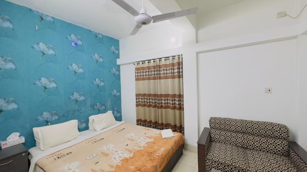 a bedroom with a bed and a ceiling fan at Chittagong Hotel & Apartment Service in Dhaka