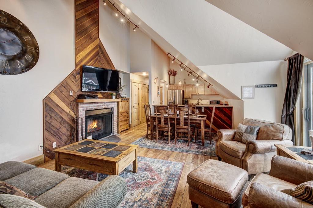 a living room with a fireplace and a table at Unbelievable Location on Main Street - Walk Everywhere, Private Hot Tub! DOG FRIENDLY SCC4 in Breckenridge