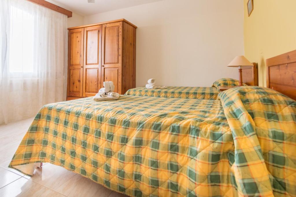 Postel nebo postele na pokoji v ubytování Horizon Apartments Gozo