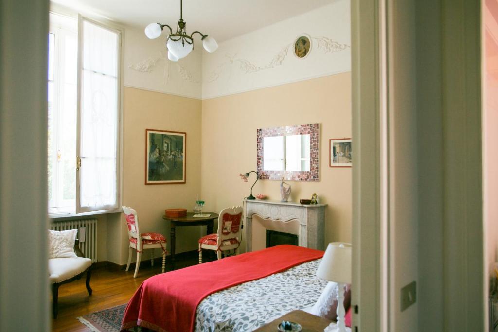 um quarto com uma cama e uma lareira em B&B Agapantus in una Villa dell'800 em Dolceacqua