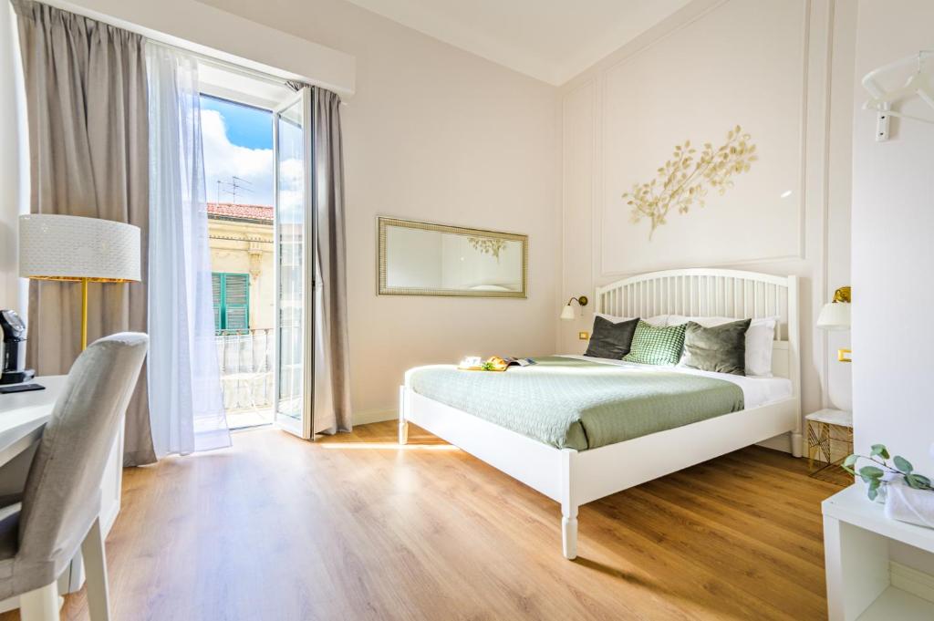 Postel nebo postele na pokoji v ubytování L'Opera Rooms & Suite