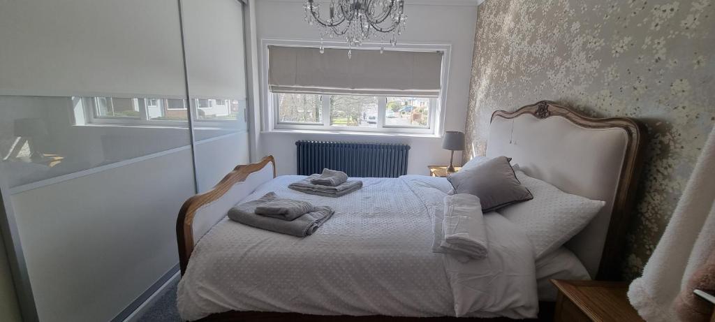 a bedroom with a bed with towels on it at Daisy Cottage, delightful 3 bedroom cottage in village location in Barrowford