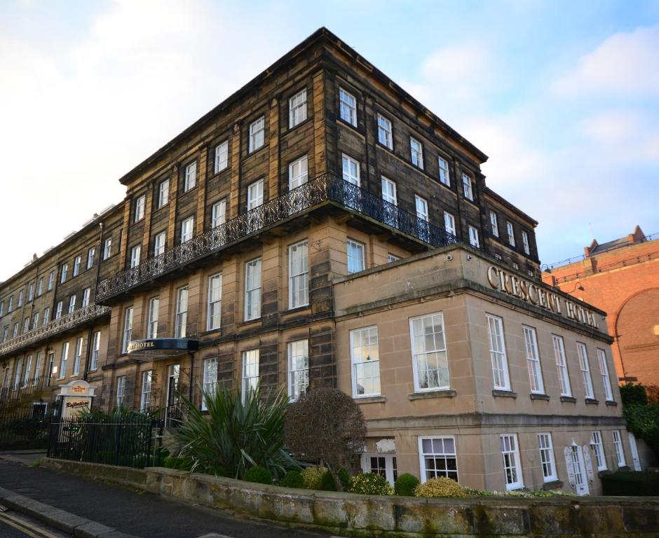 a large brick building on the side of a street at The Crescent Hotel in Scarborough