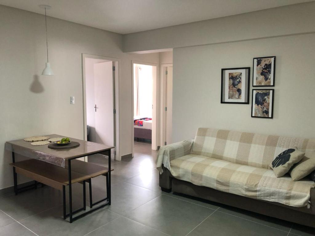 a living room with a couch and a table at Apto 70m² no centro de Porto Belo in Porto Belo