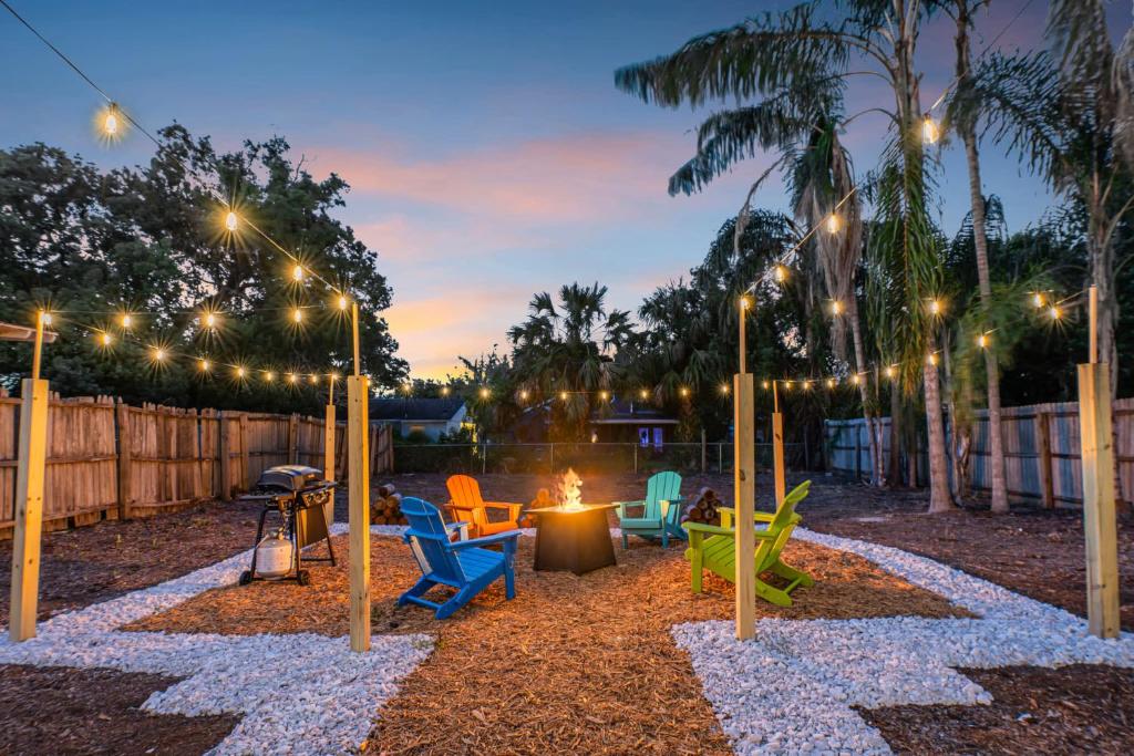 a playground with chairs and a fire pit at night at Fire Pit + Grill + 2MI to DT Orlando in Orlando