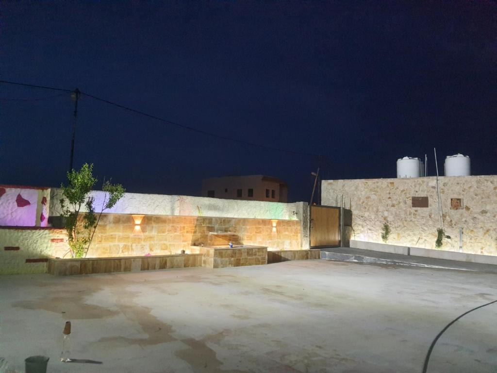 an empty parking lot in front of a building at night at Northern View in Kafr Khall